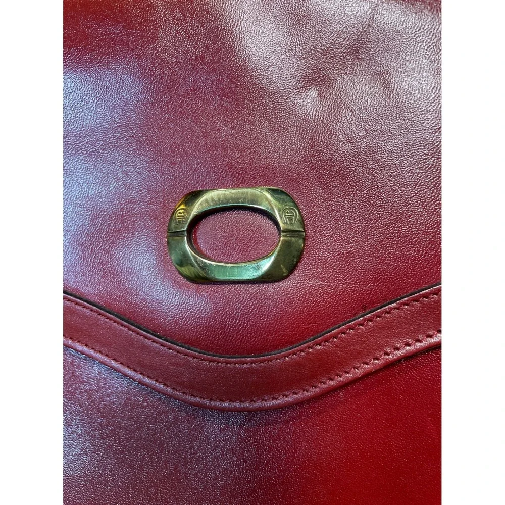 Elegant‎ Burgundy Etienne Aigner Leather Clutch Handbag with Gold Oval Accent